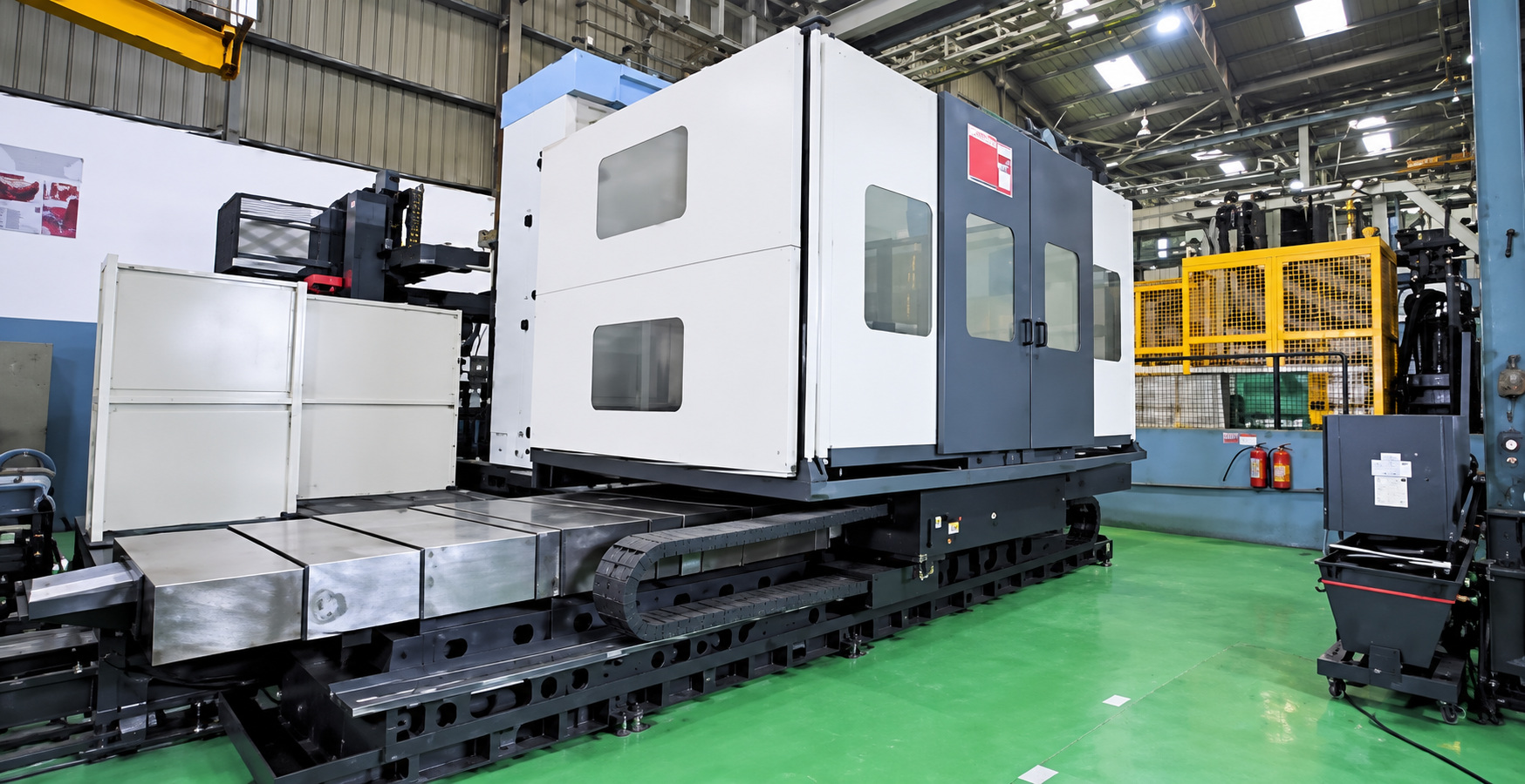 A large DMG MORI machine on a long bed